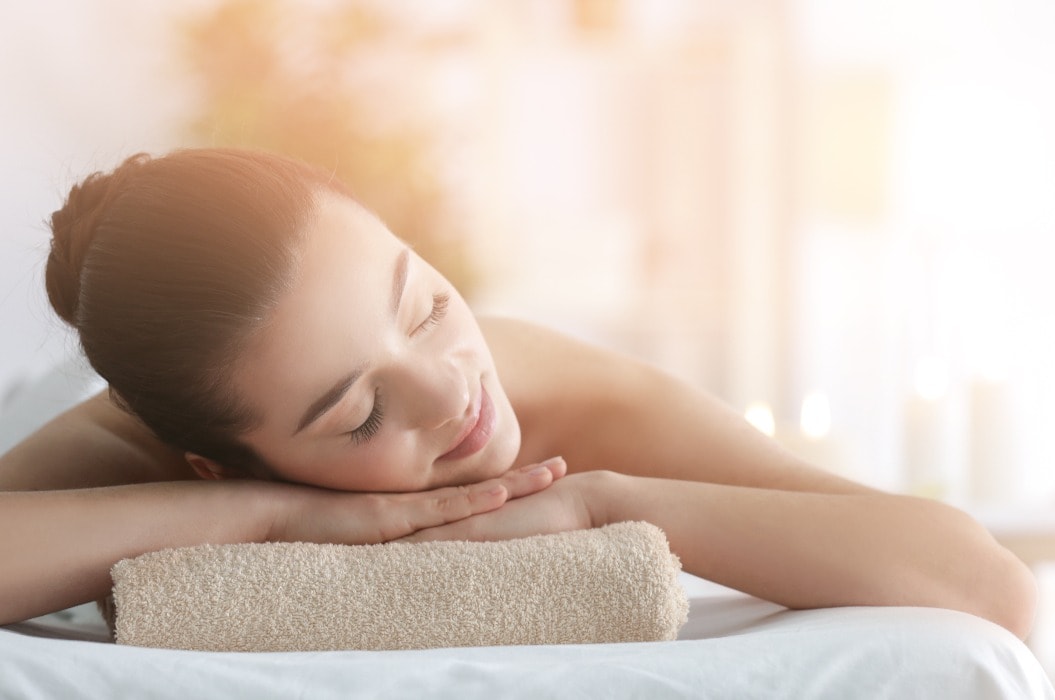 Beautiful young woman in spa salon