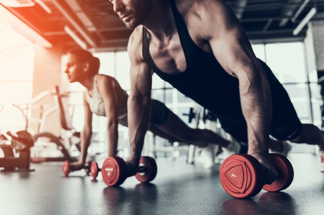 Young Man and Woman Training in Fitness Club.