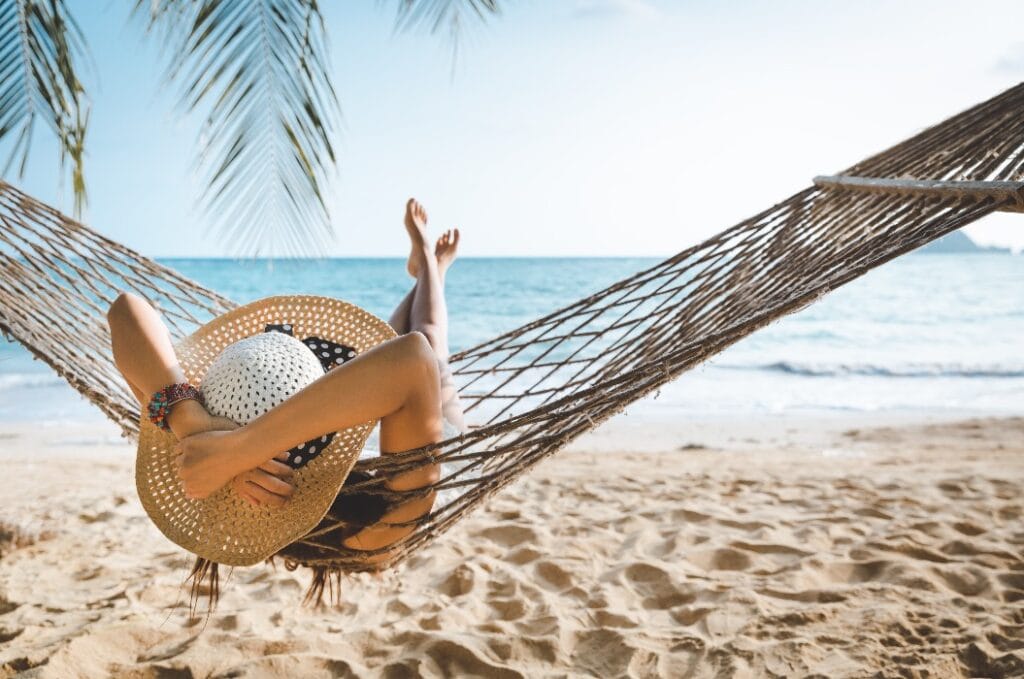Traveler asian woman relax in hammock on summer beach Thailand